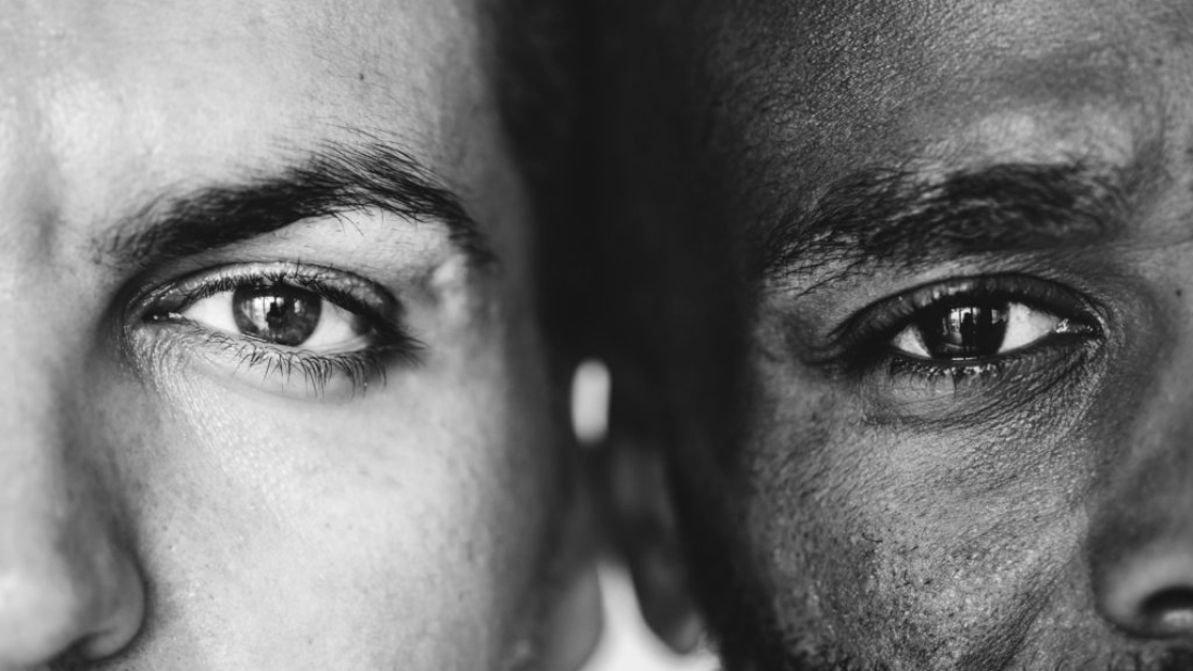 Two different ethnic men's eyes closeup