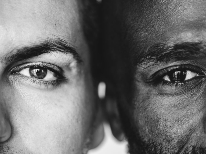 Two different ethnic men's eyes closeup